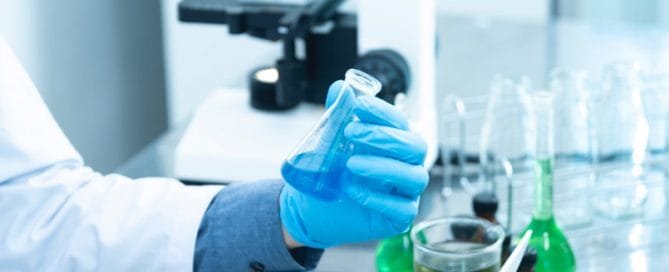 What is Chemical Dosing? 3 engineer holding laboratory flask inside a chemical lab